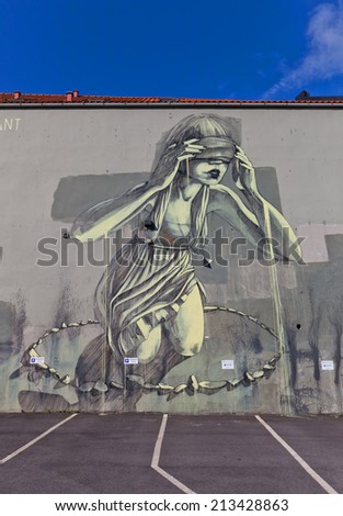 STAVANGER, NORWAY - AUGUST 16, 2014: Giant graffiti of young woman on the wall of a house in the historic center of Stavanger, Norway