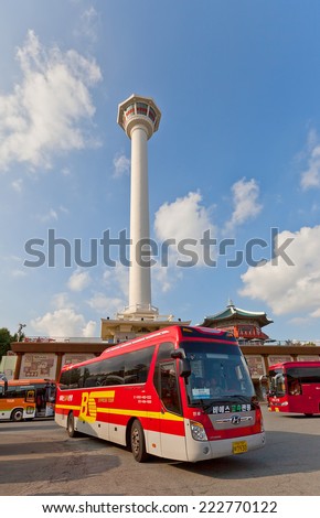 BUSAN, SOUTH KOREA - SEPTEMBER 25, 2014:  Excursion buses near Busan Tower in Yongdusan Park of Busan,  Korea. 120 m. high tower (1973) is used as a lighthouse, provides grate view over the city