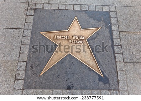 LODZ, POLAND - OCTOBER 19, 2014: Brass star for Andrzej Wajda  on Walk of Fame on central Piotrkowska Street in Lodz, Poland. Andrzej Wajda is a Polish film director, recipient of an honorary Oscar