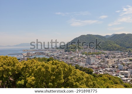SHIKOKUCHUO, JAPAN - MAY 22, 2015: View of Kawanoe town and port from Kawanoe castle in Shikokuchuo, Shikoku Island, Japan. Shikokuchuo is the leading producer of paper and paper products in Japan