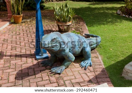 GRAND CAYMAN - JUNE 28, 2015: Sculpture of Blue Iguana (Cyclura lewisi) in Queen Elizabeth II Botanic Park of Grand Cayman, British Overseas Territory. Blue Iguana is lizard endemic of Grand Cayman