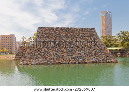 TAKAMATSU, JAPAN - MAY 22, 2015: Reconstructed stone foundation of the main keep (donjon) of Takamatsu castle, Shikoku Island, Japan. There are plans to rebuilt donjon in some years