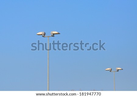 Lamp street lighting on the background of blue sky.