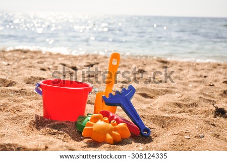 Plastic colored toys on the beach
