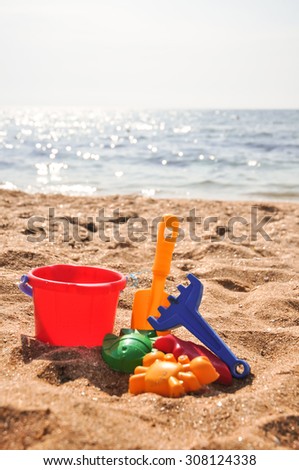 Plastic colored toys on the beach