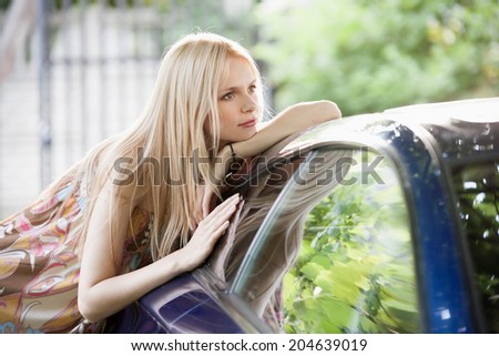 beautiful portrait  blonde woman in car background