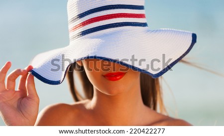 beautiful  face brunette woman with white hat has smiling red lips and  tan skin