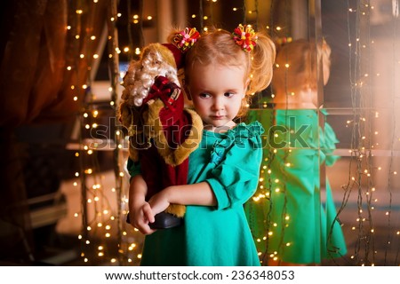 beautiful  smiling  little blonde girl  with  soft toy on christmas  lights background birthday fresh trendy joy happy look cute studio impressions lady