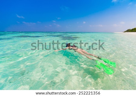 beautiful women  with flippers, mask and tube snorkeling in Maldives  romantic  atoll island paradise luxury  resort about coral reef amazing  fresh  freedom  adventure