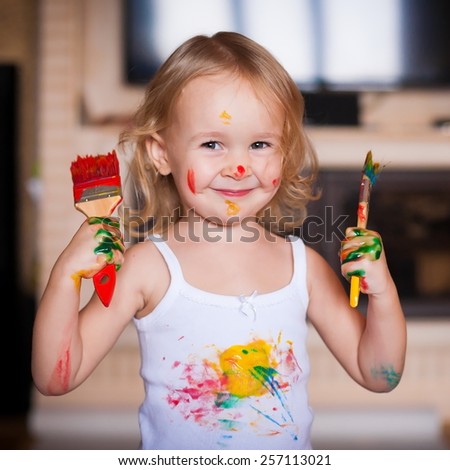 beautiful  smiling  little blonde girl  with brush  paints amazing fresh trendy summer spring joy happy look cute studio impressions lady