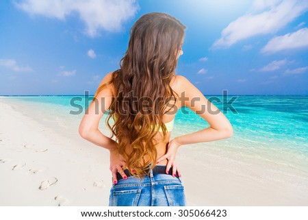 Portrait pretty fun joy sexy back brunette woman, has yellow bikini bra, blue jeans shorts, tan sport  body. Sun tropical hot blue sea  water resort. Travel rest nature. Amazing lifestyle. Azure sky