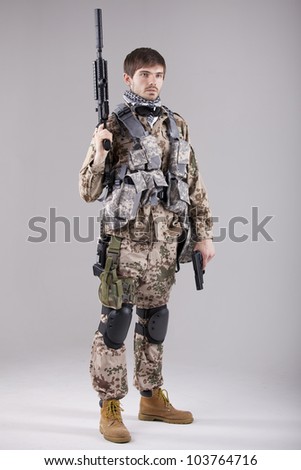Portrait of Armed Soldier with two guns in a white studio