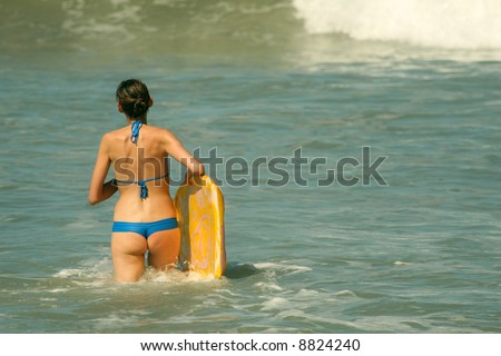 Bikini Girl with boogie board in the water