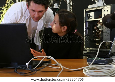 man and woman working on computer in the labor