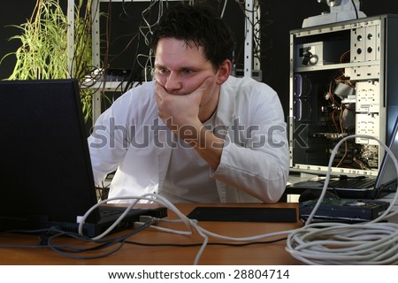 man thinking about problems on computer in the repair plant