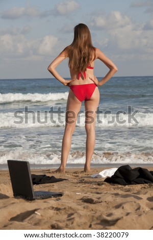 woman on the beach - laptop, jacket, blouse lying in sand