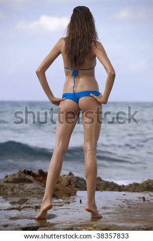 woman in bikinis on the beach, shot from behind