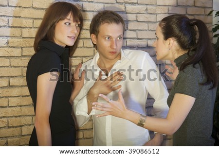 conflict between friends - angry woman speaks to the couple