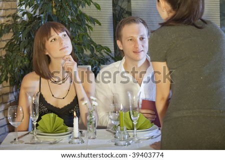 man in restaurant looking at waitress breasts