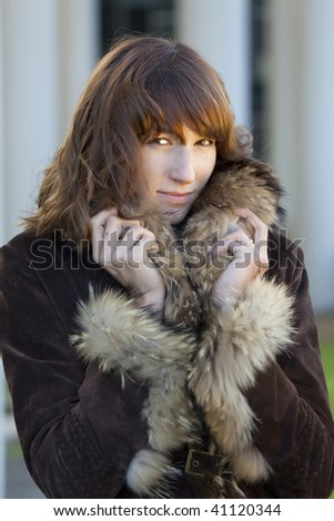 portrait of elegant woman in fur coat outdoor