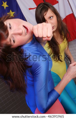 two women fighting in a cage