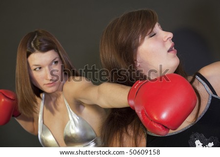 Two young ladies in a boxing competition - face punch