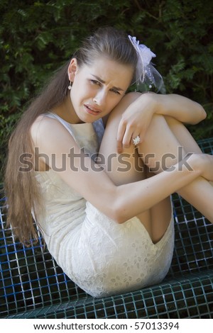 sad and unhappy bride crying on the bench