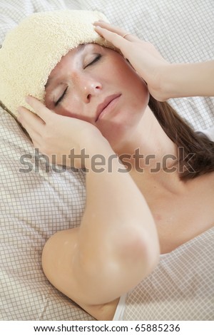 sick woman lying with fever in bed