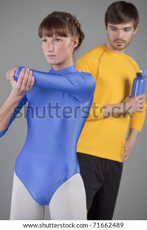 horny man in fitness studio looking at woman in blue leotard