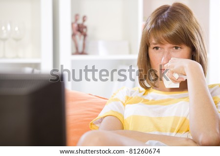 crying woman watching drama on television