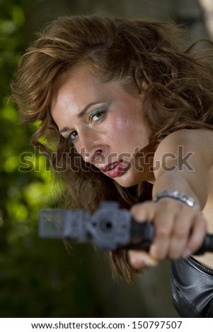 Angry gun woman shooting from a handgun