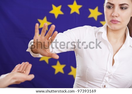 begging hand to european union and rejecting or stop gesture from a young woman