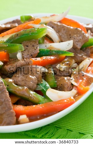 Chinese pepper steak - slices of tender beef stir-fried with red and green bell peppers and onions.