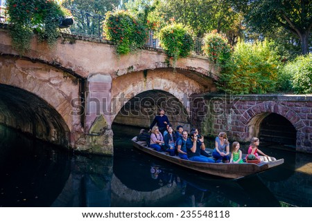 COLMAR, FRANCE - SEPTEMBER 27, 2014: People sit in boat while visit Colmar, France or Little Venice.