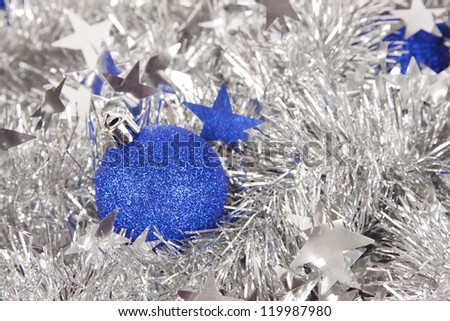 blue ornament ball on christmas silver tinsel