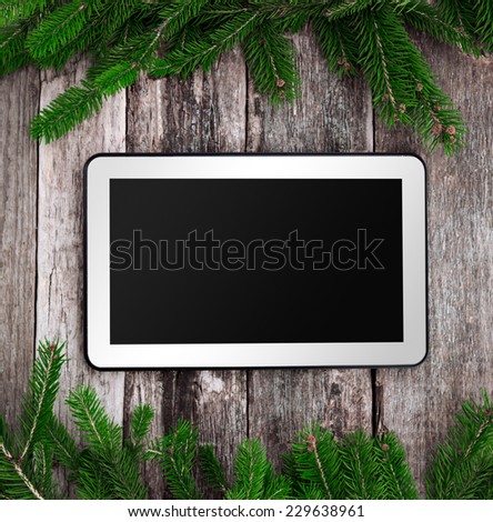 Blank tablet with Christmas decoration ornaments with pine tree