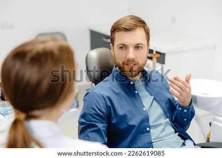 Similar – Image, Stock Photo Young bearded male dentist drilling tooth to female patient