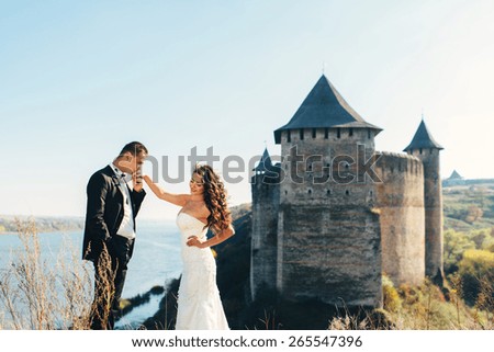 Walk just married on the background of the old castle