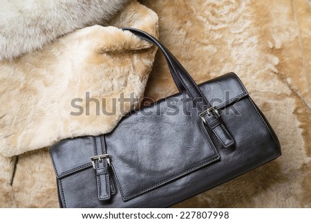 A black leather bag of warm blond sheepskin, blue fox and red sable mink furs