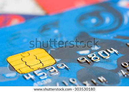 Macro detail of the numbers on a plastic credit card with golden electronic chip
