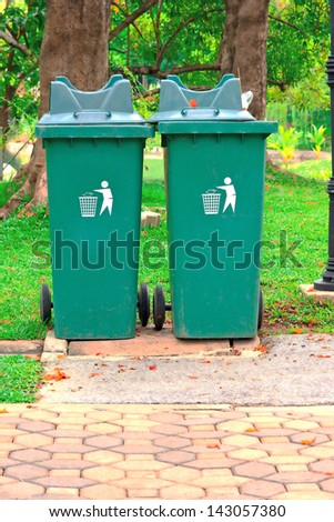The two trash green in garden , around  see in area