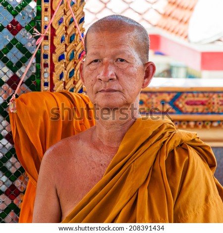 Ratchaburi, Thailand - May 24, 2014: Buddhist monk poses for a photo at buddhist temple from Damnoen Saduak Floating Market, Thailand.Buddhism is the primary religion in Thailand.