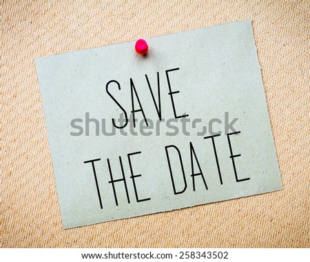 Recycled paper note pinned on cork board.Save the Date Message. Wedding Concept Image
