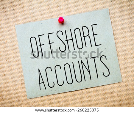 Recycled paper note pinned on cork board. Offshore Accounts Message. Concept Image