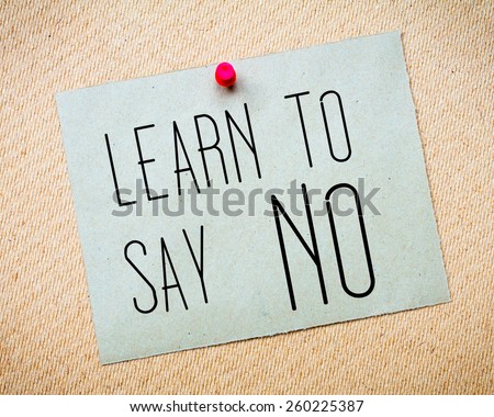 Recycled paper note pinned on cork board. Learn to say NO Message. Concept Image