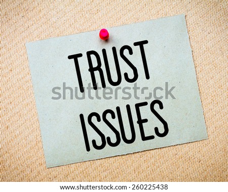 Recycled paper note pinned on cork board. Trust Issues Message. Concept Image