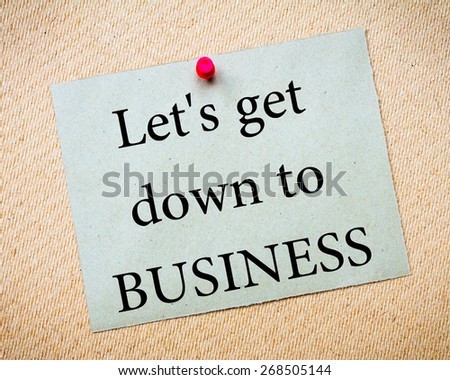 Let's get down to BUSINESS Message. Recycled paper note pinned on cork board. Concept Image
