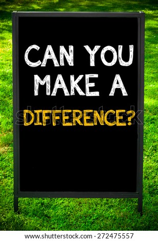 CAN YOU MAKE A DIFFERENCE?  message on sidewalk blackboard sign against green grass background. Copy Space available. Concept image