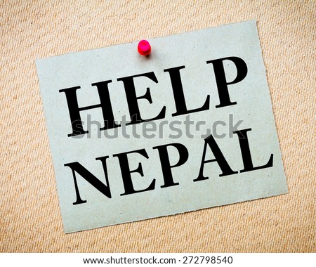HELP NEPAL Note. Recycled paper note pinned on cork board. Concept Image