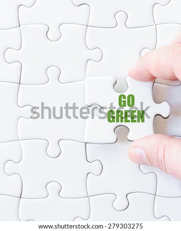 Missing jigsaw puzzle piece with words  GO GREEN. Business concept image for completing the puzzle.